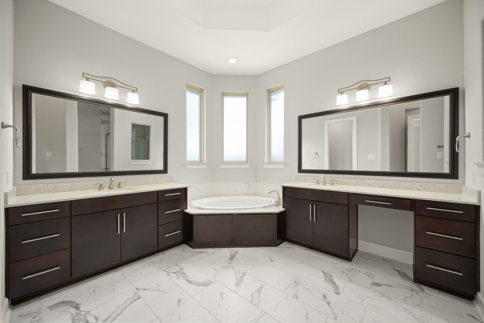 3622 Sage Hollow Drive Spring, TX 77386 - Photo 18 of 46 The primary ensuite bathroom, exquisitely appointed with a relaxing drop-in jetted tub, custom tile flooring, a dedicated makeup vanity space, and separate double-sink vanities.