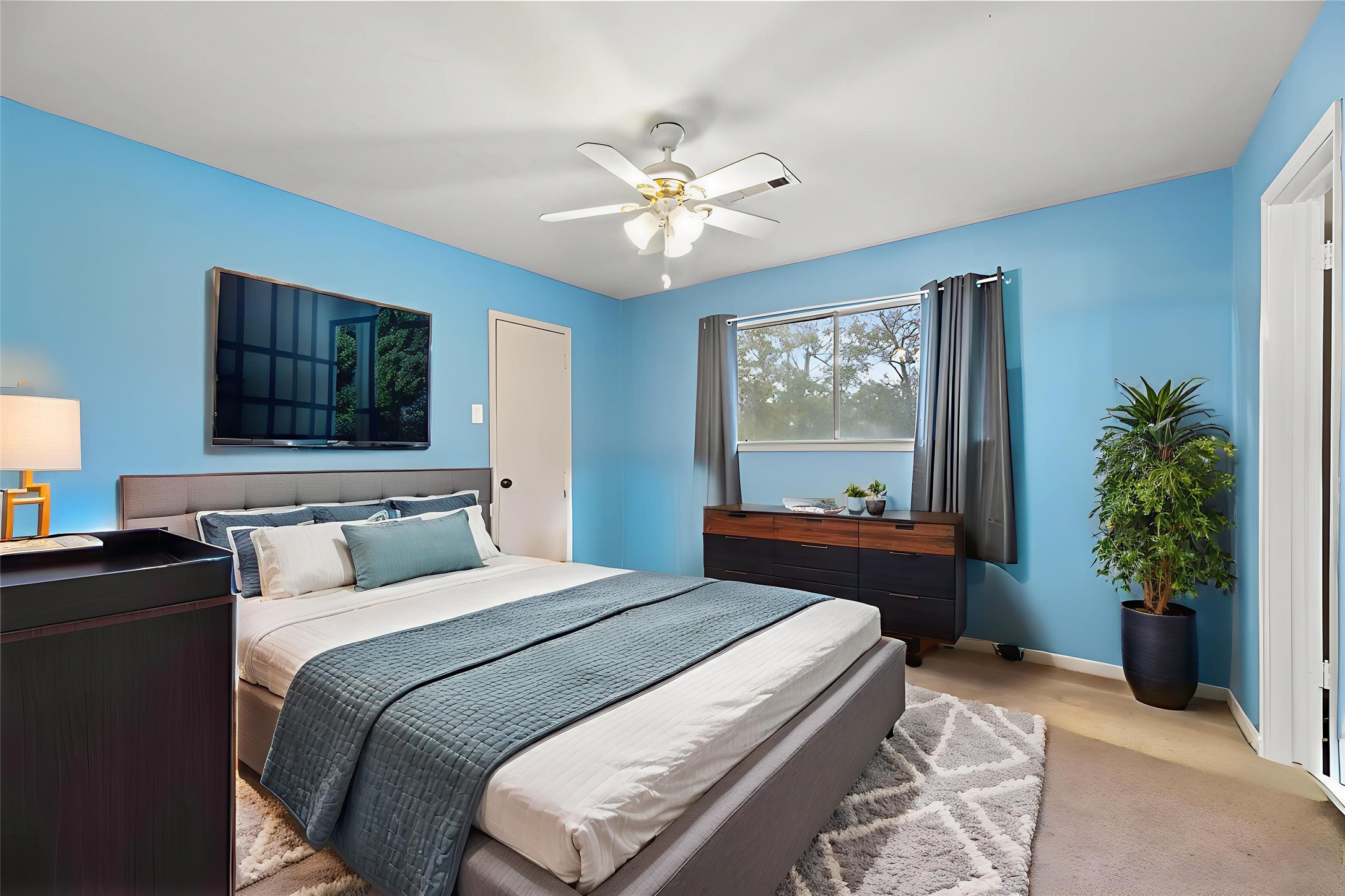 17814 Theiss Mail Rte Road Spring, TX 77379 - Photo 13 of 24 a bedroom with a bed and a chandelier