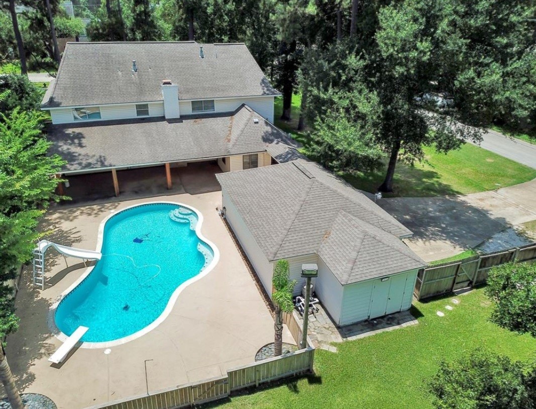 17814 Theiss Mail Rte Road Spring, TX 77379 - Photo 19 of 24 an aerial view of a house with swimming pool and large trees