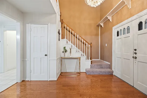 a view of a hallway with wooden floor and staircase