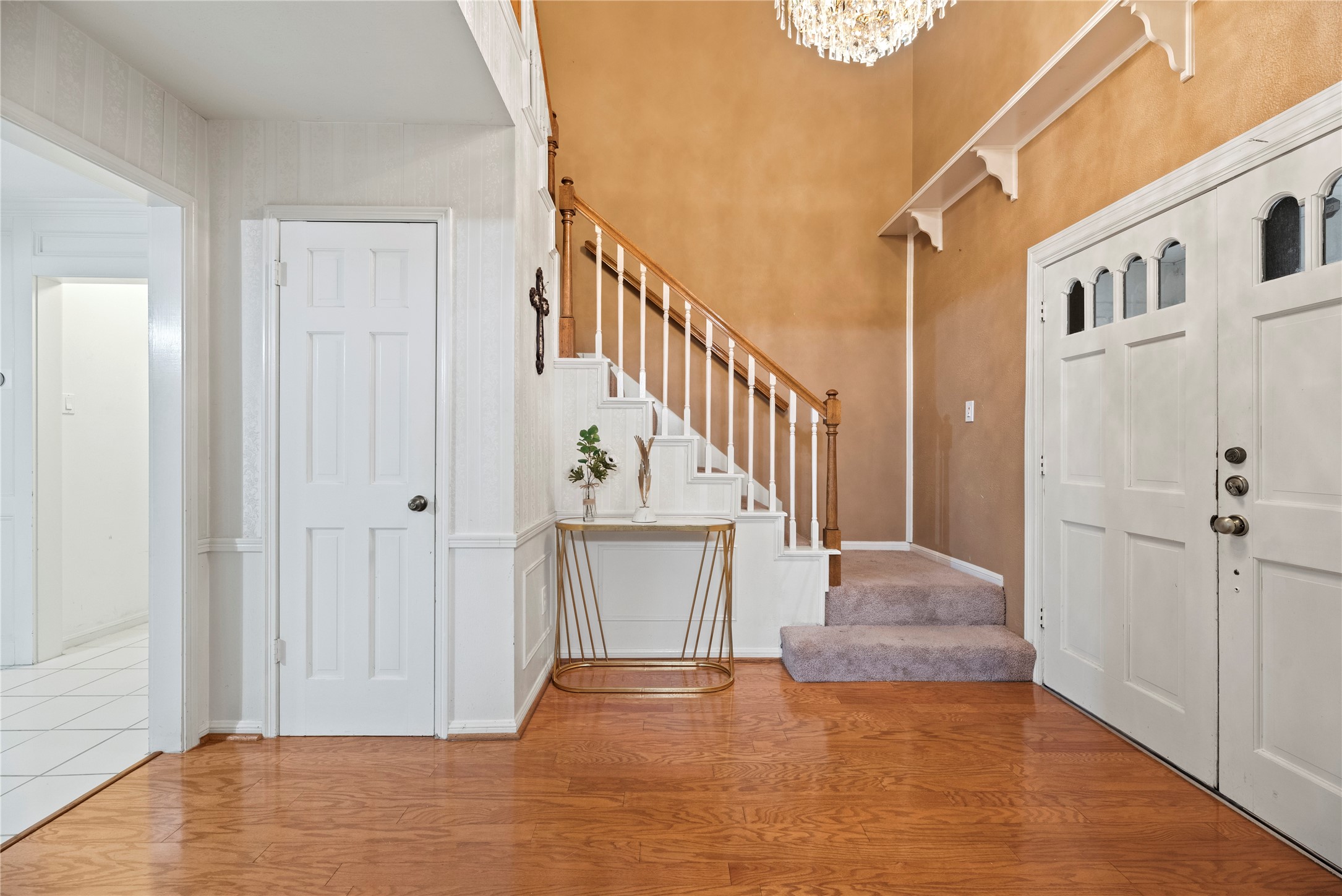 17814 Theiss Mail Rte Road Spring, TX 77379 - Photo 3 of 24 a view of a hallway with wooden floor and staircase
