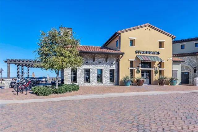 a front view of a house with plants and trees