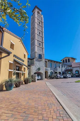 a front view of a building with cars parked