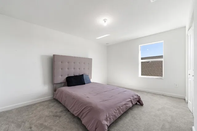 a bedroom with a bed and a fireplace