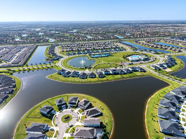 an aerial view of a swimming pool a yard and ocean view