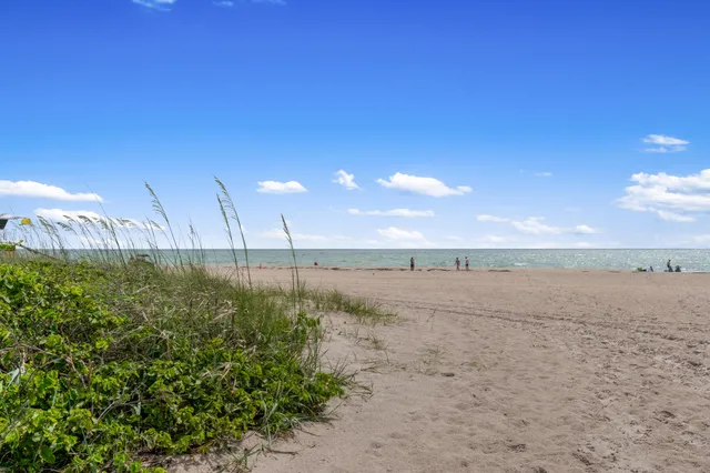 an aerial view of residential houses with outdoor space and swimming pool