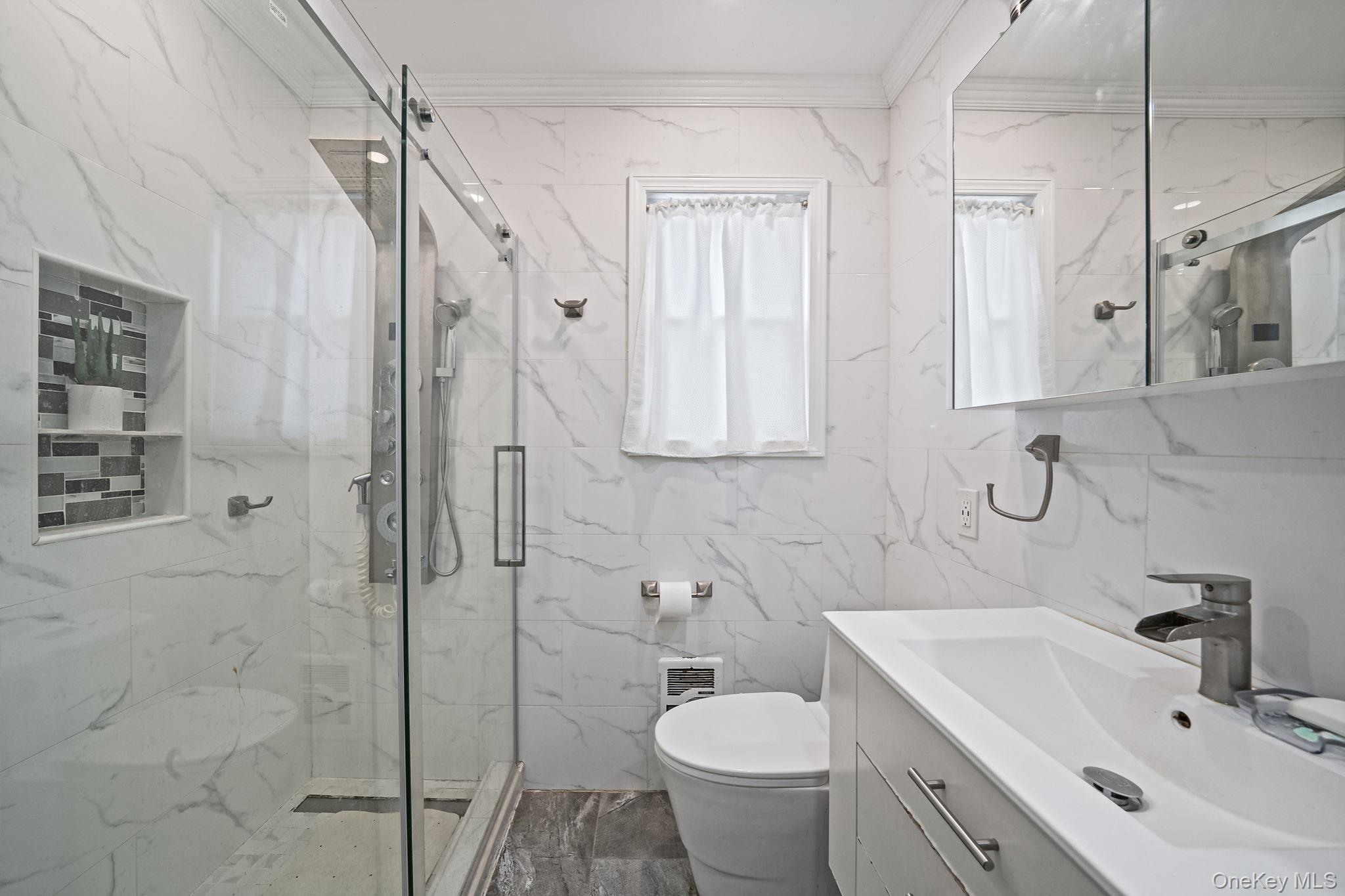 12 Edna Court Valley Stream, NY 11580 - Photo 15 of 20 a bathroom with a sink toilet and shower