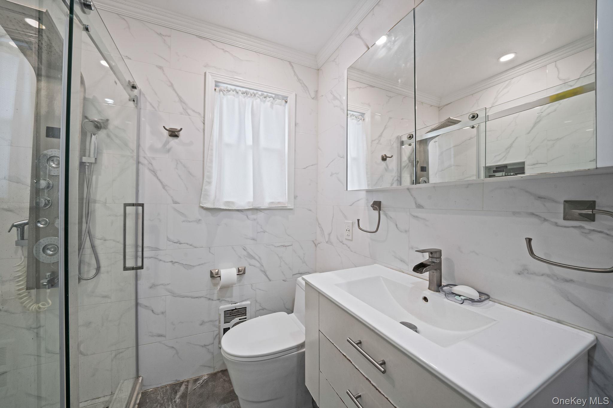 12 Edna Court Valley Stream, NY 11580 - Photo 16 of 20 a bathroom with a sink toilet and shower