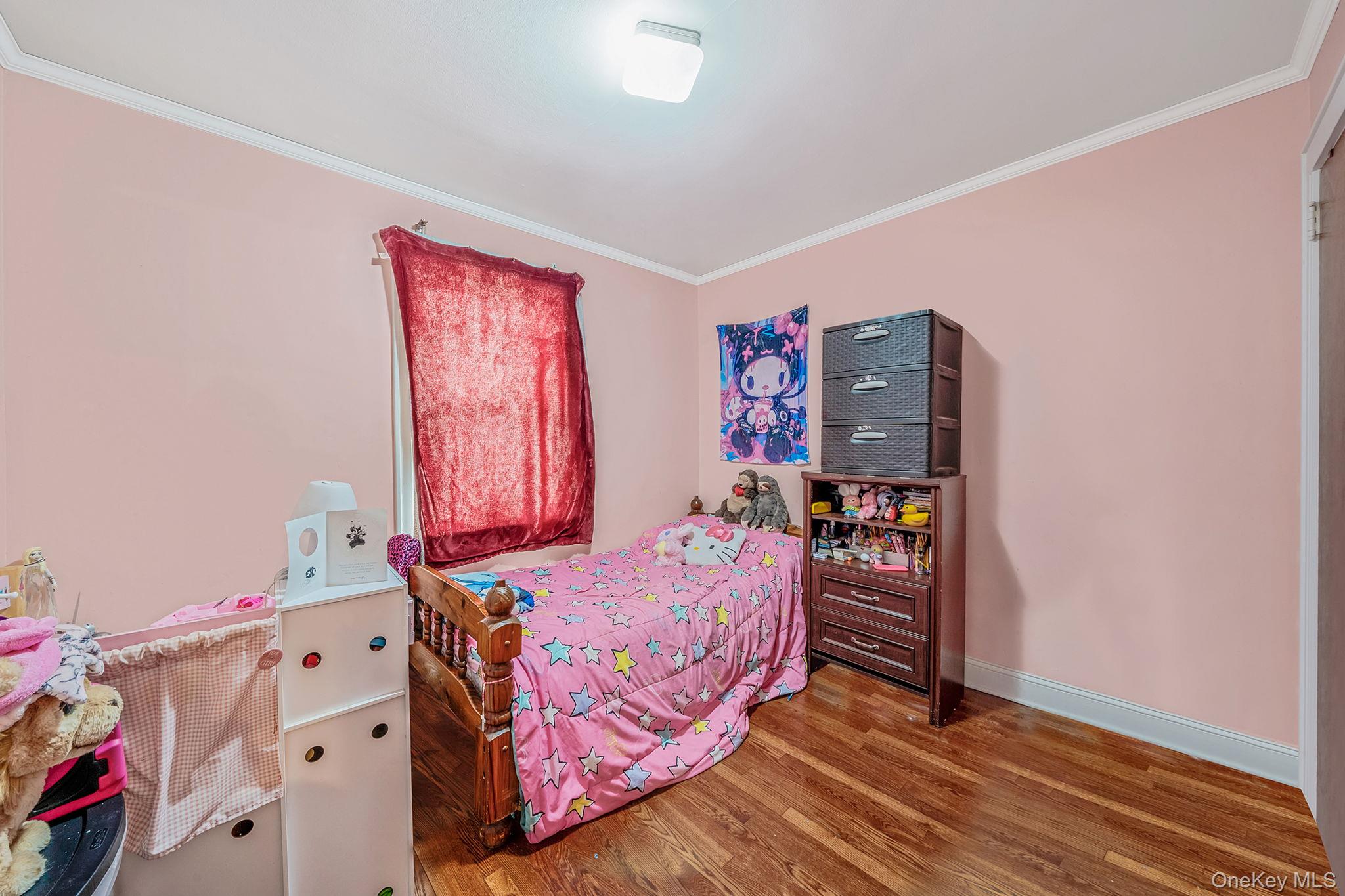 12 Edna Court Valley Stream, NY 11580 - Photo 17 of 20 a bedroom with a bed and wooden floor