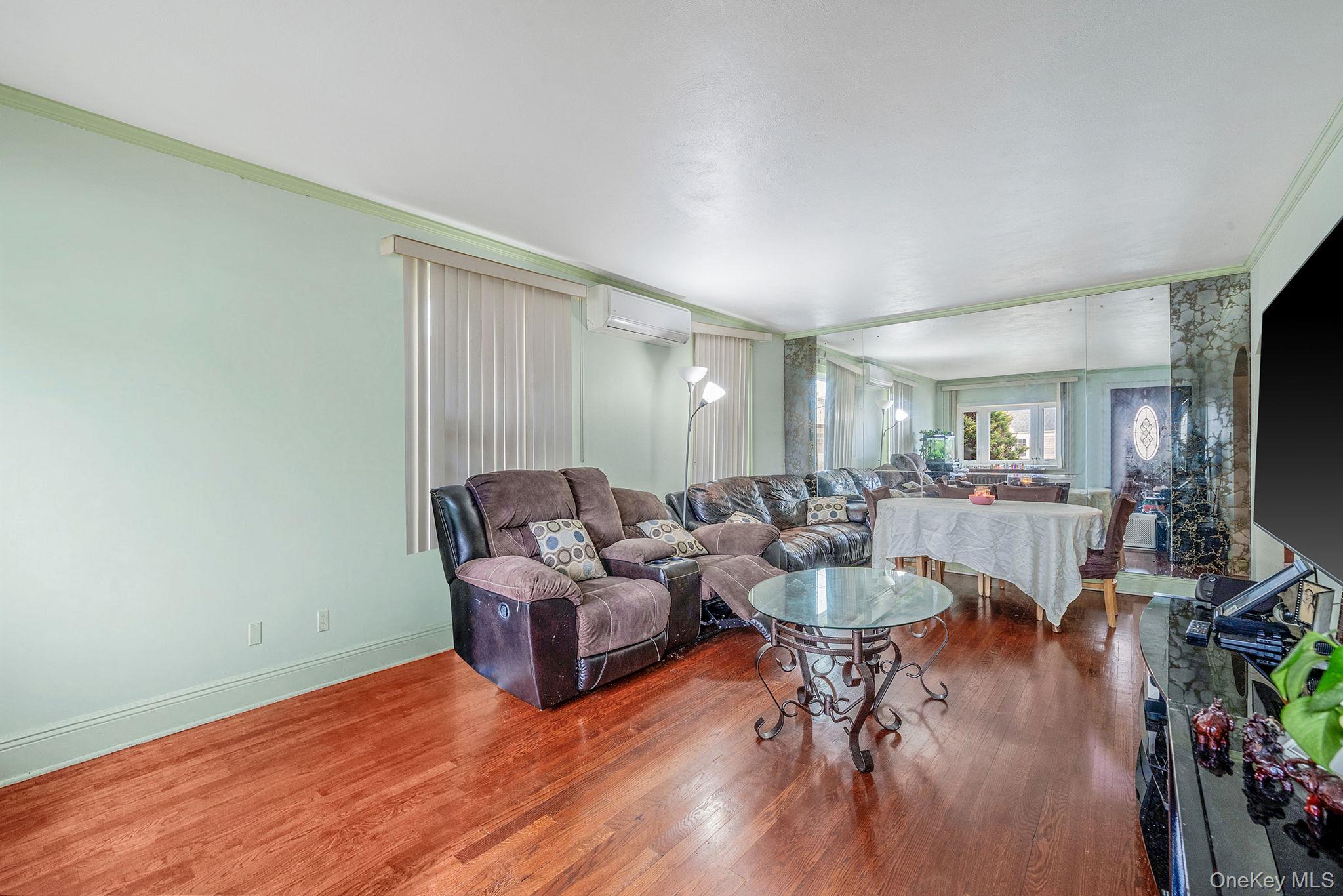 12 Edna Court Valley Stream, NY 11580 - Photo 7 of 20 a living room with fireplace furniture and a wooden floor