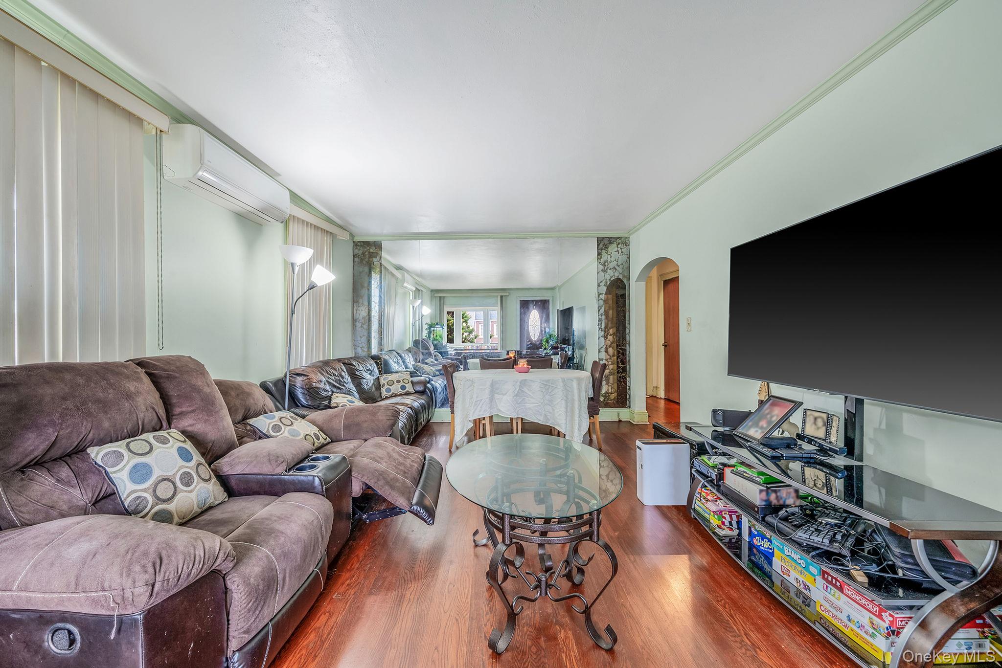 12 Edna Court Valley Stream, NY 11580 - Photo 8 of 20 a living room with furniture and a flat screen tv