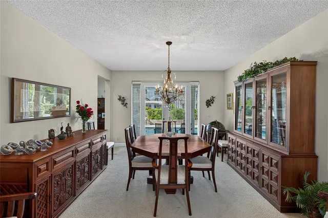 a kitchen with stainless steel appliances granite countertop a refrigerator a stove and a sink