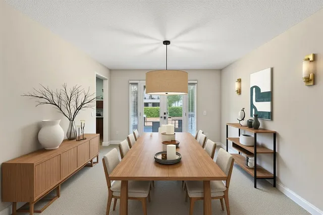 a living room with furniture a flat screen tv and kitchen view