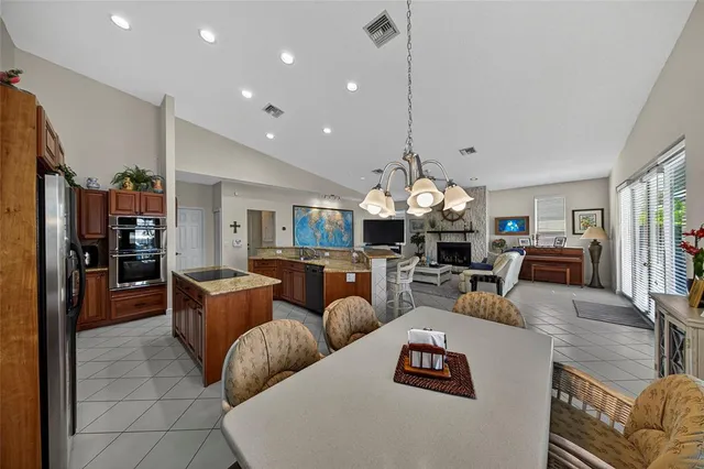 a spacious bathroom with a granite countertop sink a mirror and a bathtub