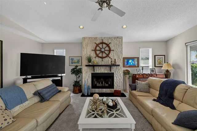 a bathroom with a granite countertop sink toilet mirror vanity and bathtub