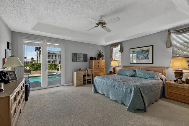 a bedroom with a large bed and a chandelier