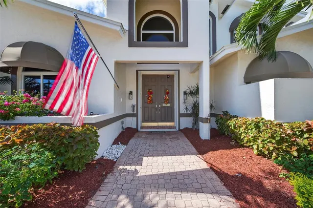 a living room with furniture a fireplace and a large window