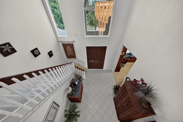 a view of a dining room with furniture and chandelier