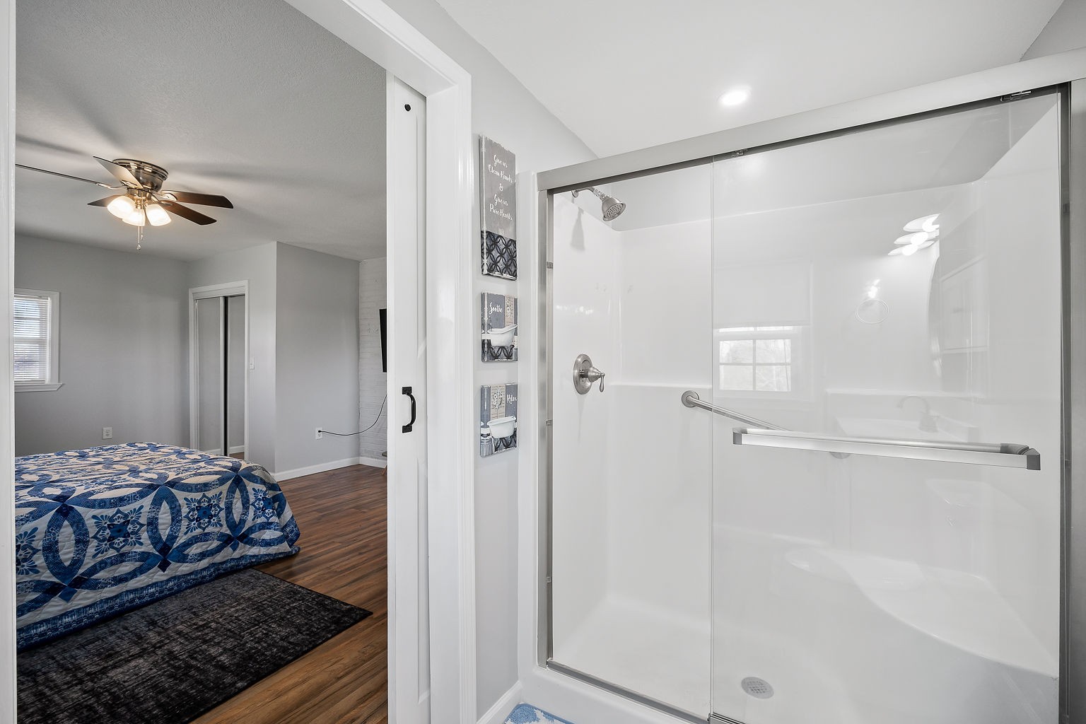 9025 Austin Bottom Road Baxter, TN 38544 - Photo 15 of 35 a bedroom with a large bed and a glass door shower