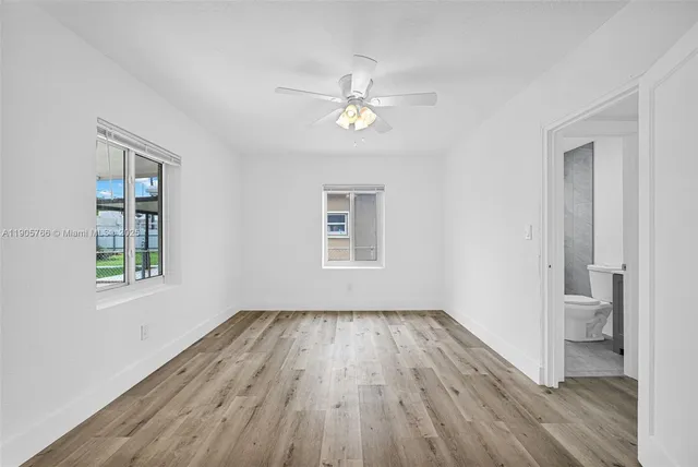 a view of a room with wooden floor