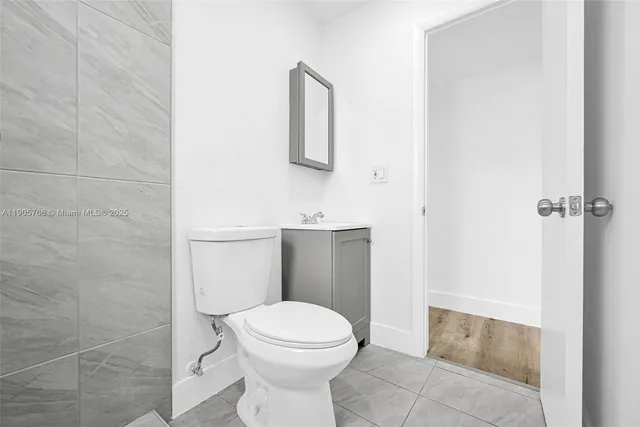 a view of a big room with wooden floor and windows