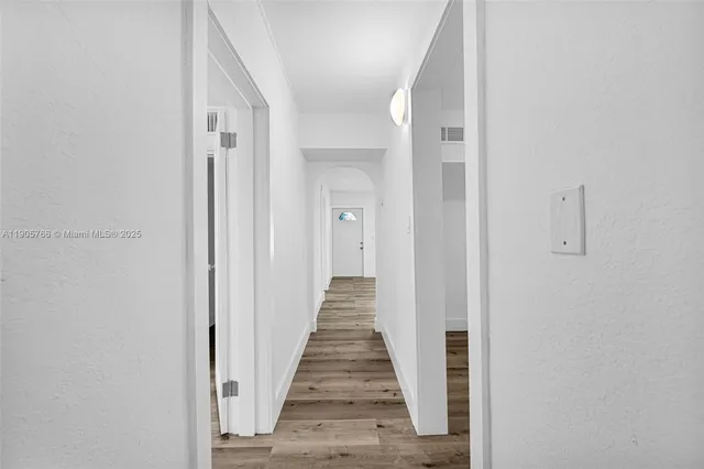 a backyard of a house with plants and outdoor seating