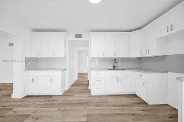 a view of a room with wooden floor