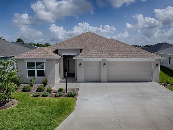 a front view of house with yard and green space