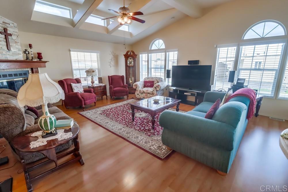 9500 Harritt Road, Unit 213 Lakeside, CA 92040 - Photo 13 of 25 a living room with furniture a flat screen tv and a large window