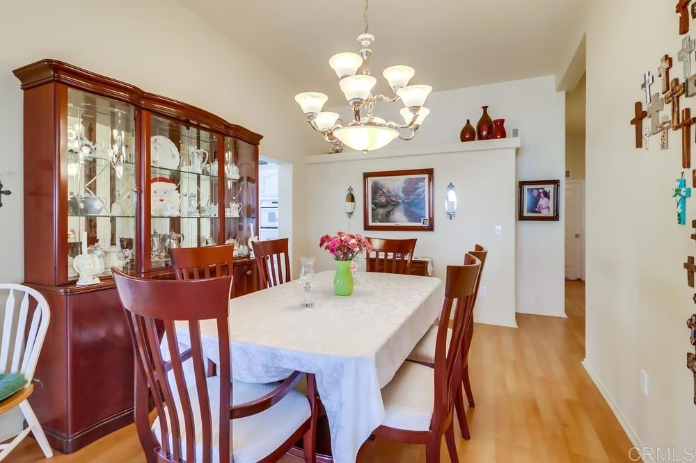 9500 Harritt Road, Unit 213 Lakeside, CA 92040 - Photo 16 of 25 a view of a dining room with furniture a chandelier and wooden floor