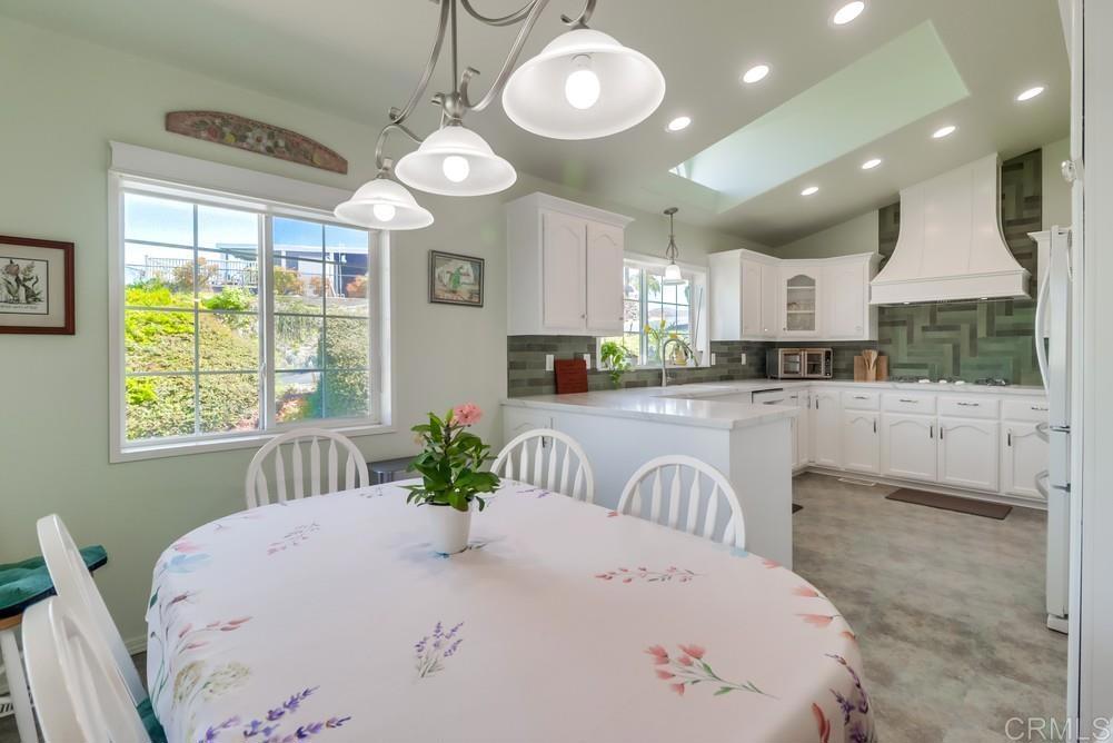 9500 Harritt Road, Unit 213 Lakeside, CA 92040 - Photo 17 of 25 a kitchen with stainless steel appliances kitchen island granite countertop a stove a sink dishwasher and white cabinets with wooden floor