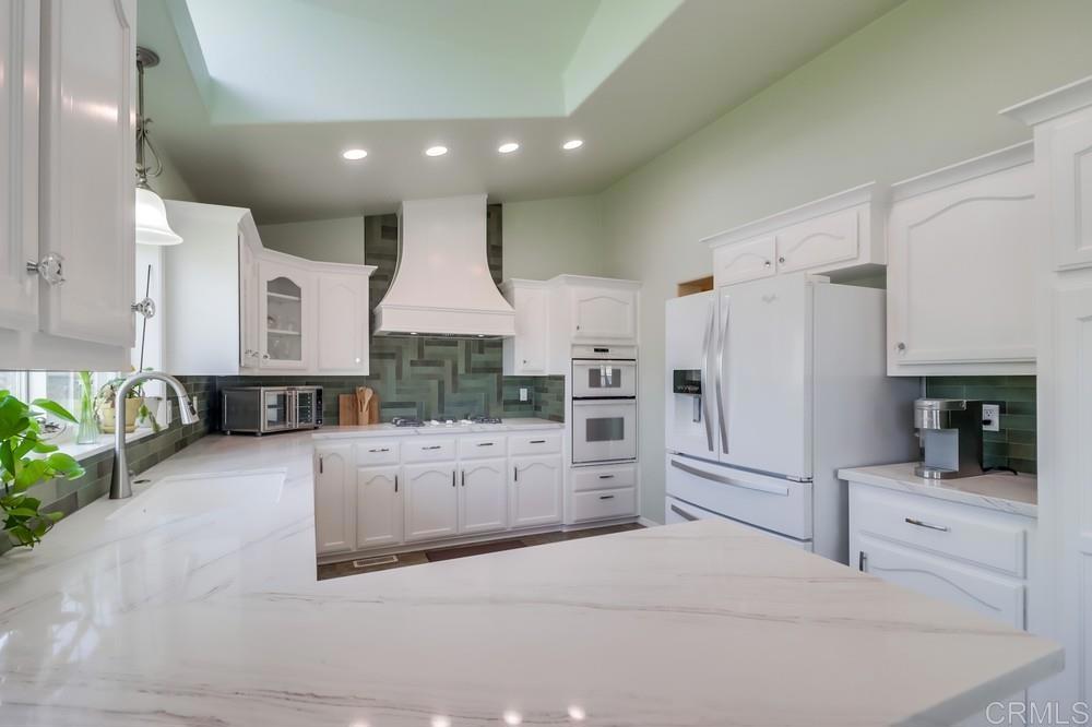 9500 Harritt Road, Unit 213 Lakeside, CA 92040 - Photo 19 of 25 a large white kitchen with cabinets