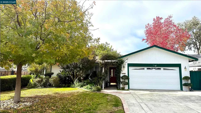 a view of a house with a yard and garage