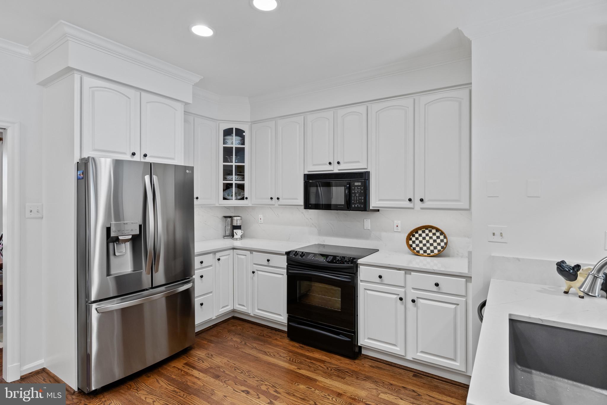 8027 Strauff Road, Unit 6 Towson, MD 21204 - Photo 11 of 39 a kitchen with stainless steel appliances white cabinets and a refrigerator