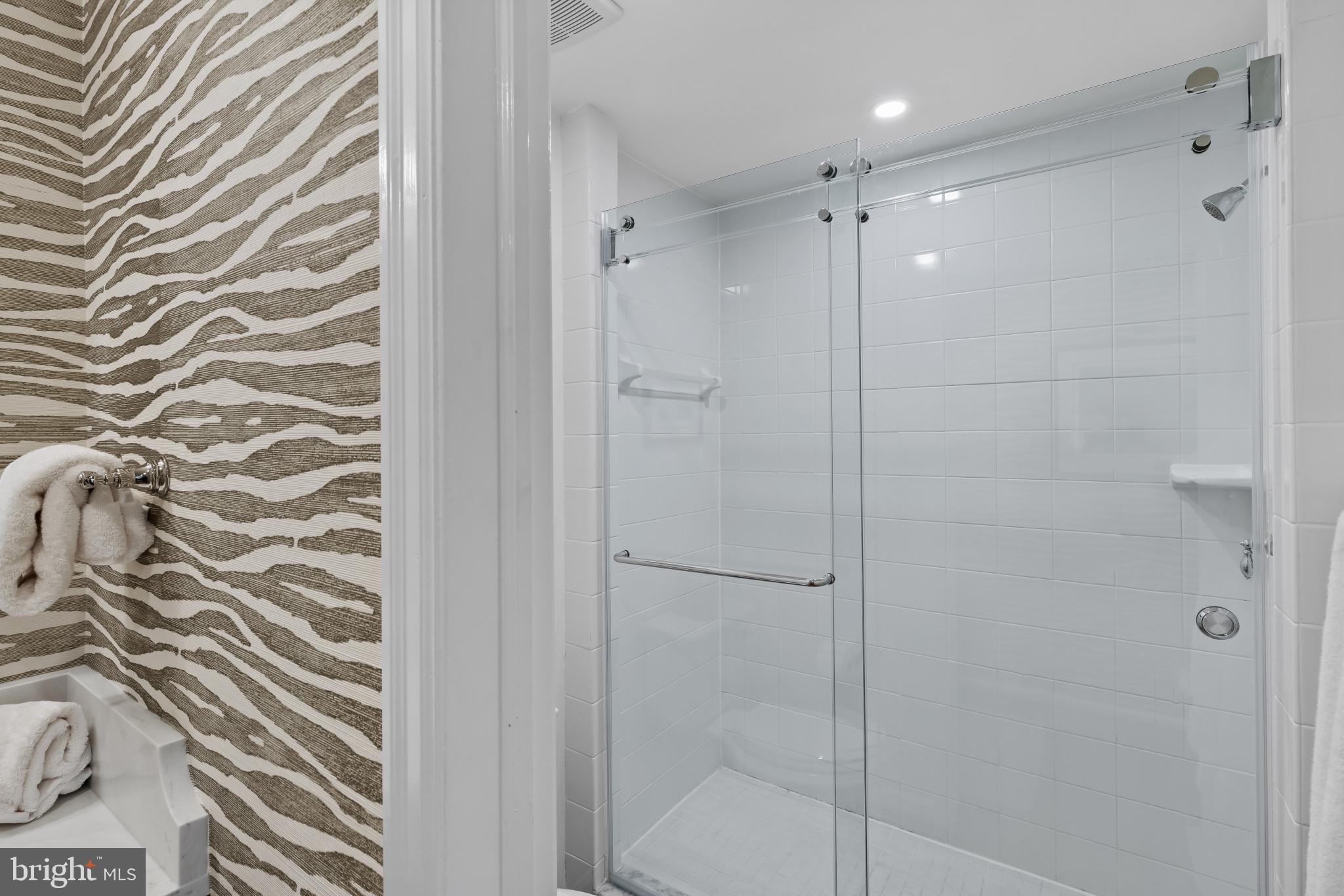 8027 Strauff Road, Unit 6 Towson, MD 21204 - Photo 18 of 39 a bathroom with a shower and a glass door