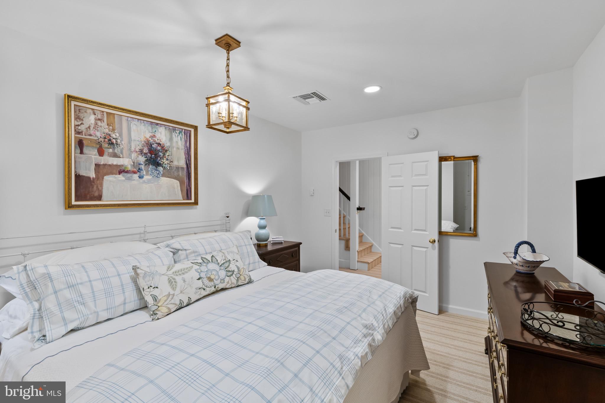 8027 Strauff Road, Unit 6 Towson, MD 21204 - Photo 26 of 39 a bedroom with a bed and a lamp
