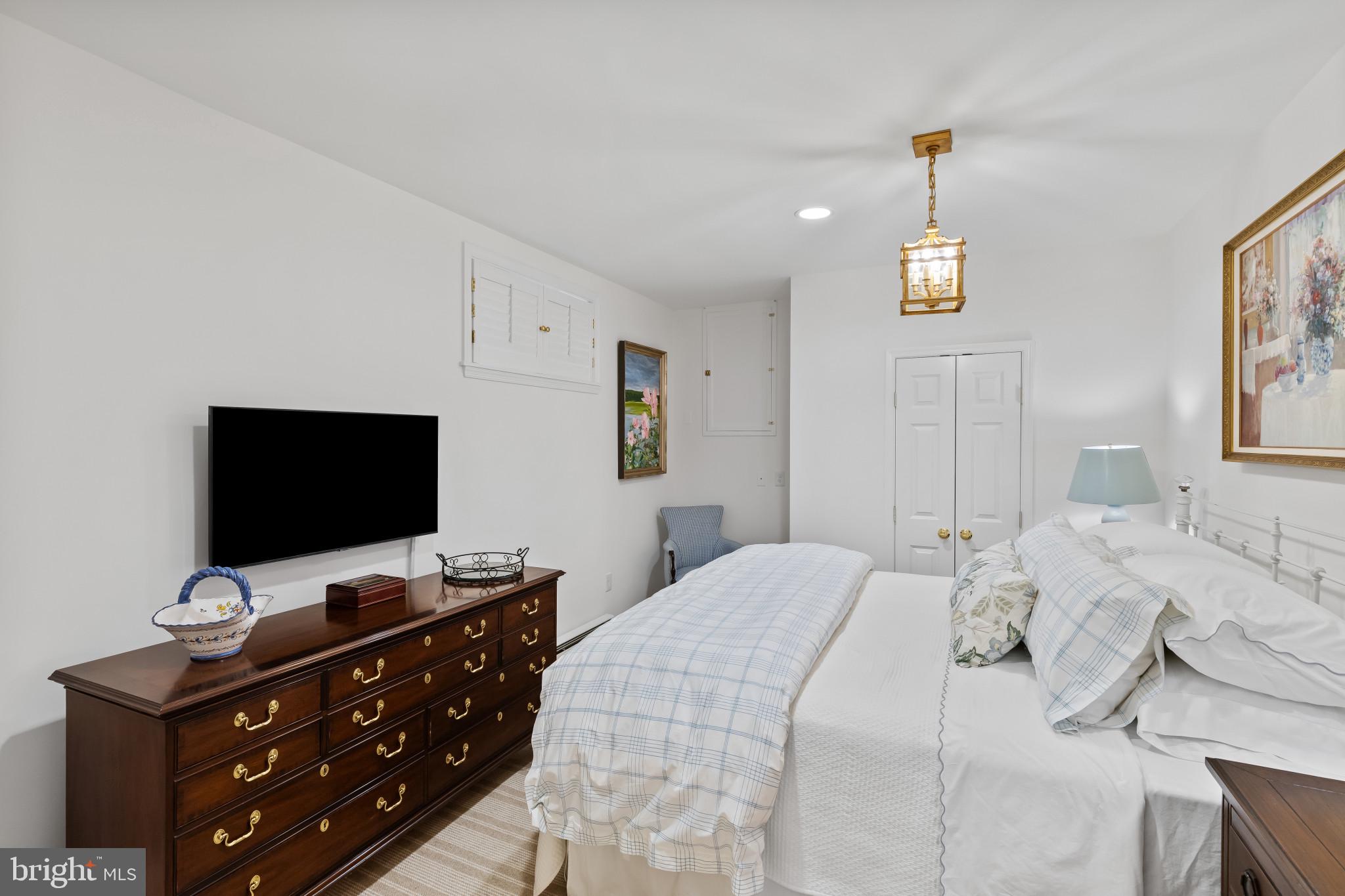 8027 Strauff Road, Unit 6 Towson, MD 21204 - Photo 27 of 39 a bedroom with a bed and a flat screen tv