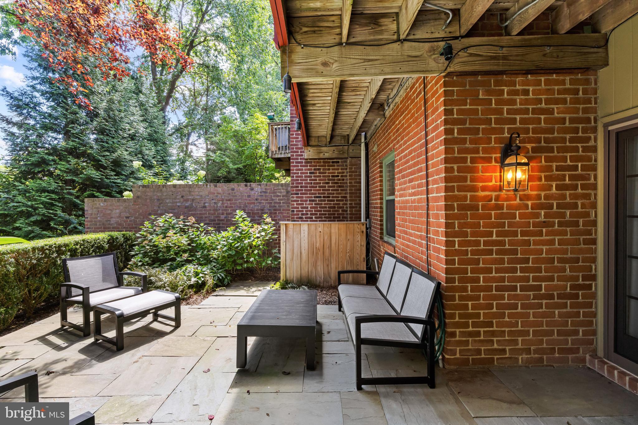 8027 Strauff Road, Unit 6 Towson, MD 21204 - Photo 33 of 39 a view of a patio with a table and chairs and potted plants
