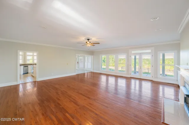 a view of a white house with a yard and plants