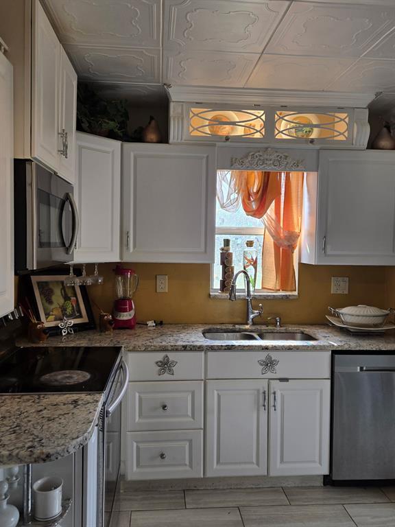 a kitchen with stainless steel appliances granite countertop a sink stove and cabinets