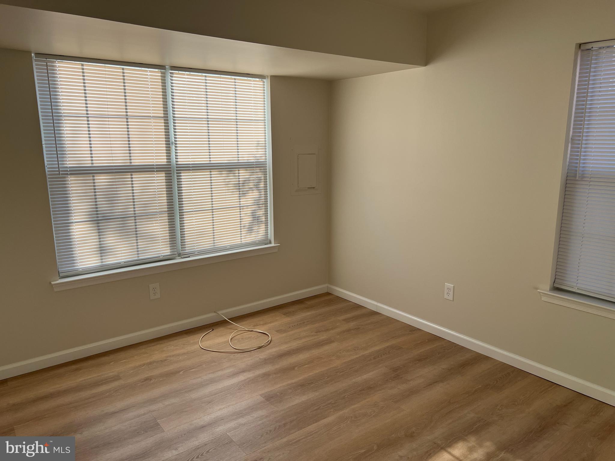 83 West Laurel Avenue Cheltenham, PA 19012 - Photo 18 of 19 an empty room with wooden floor and windows