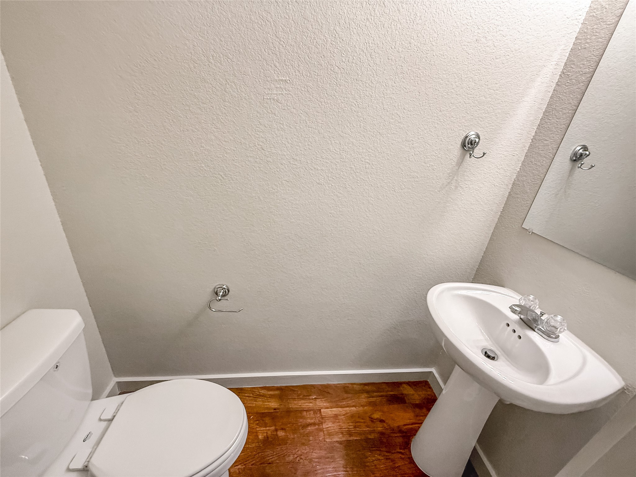 10535 Mills Road, Unit 4B Houston, TX 77070 - Photo 15 of 28 a white toilet sitting next to a bathroom sink