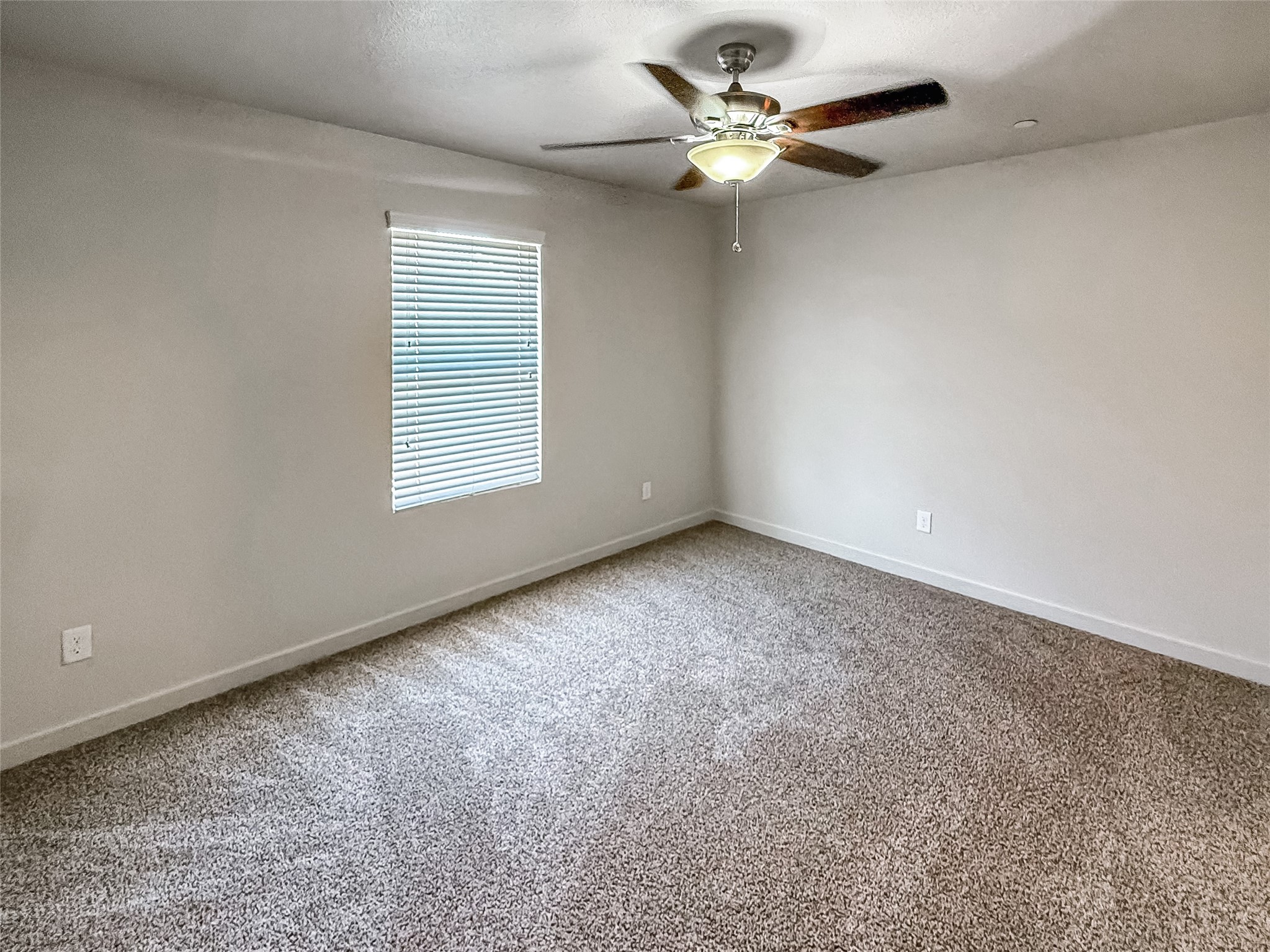 10535 Mills Road, Unit 4B Houston, TX 77070 - Photo 16 of 28 an empty room with a window and a fan