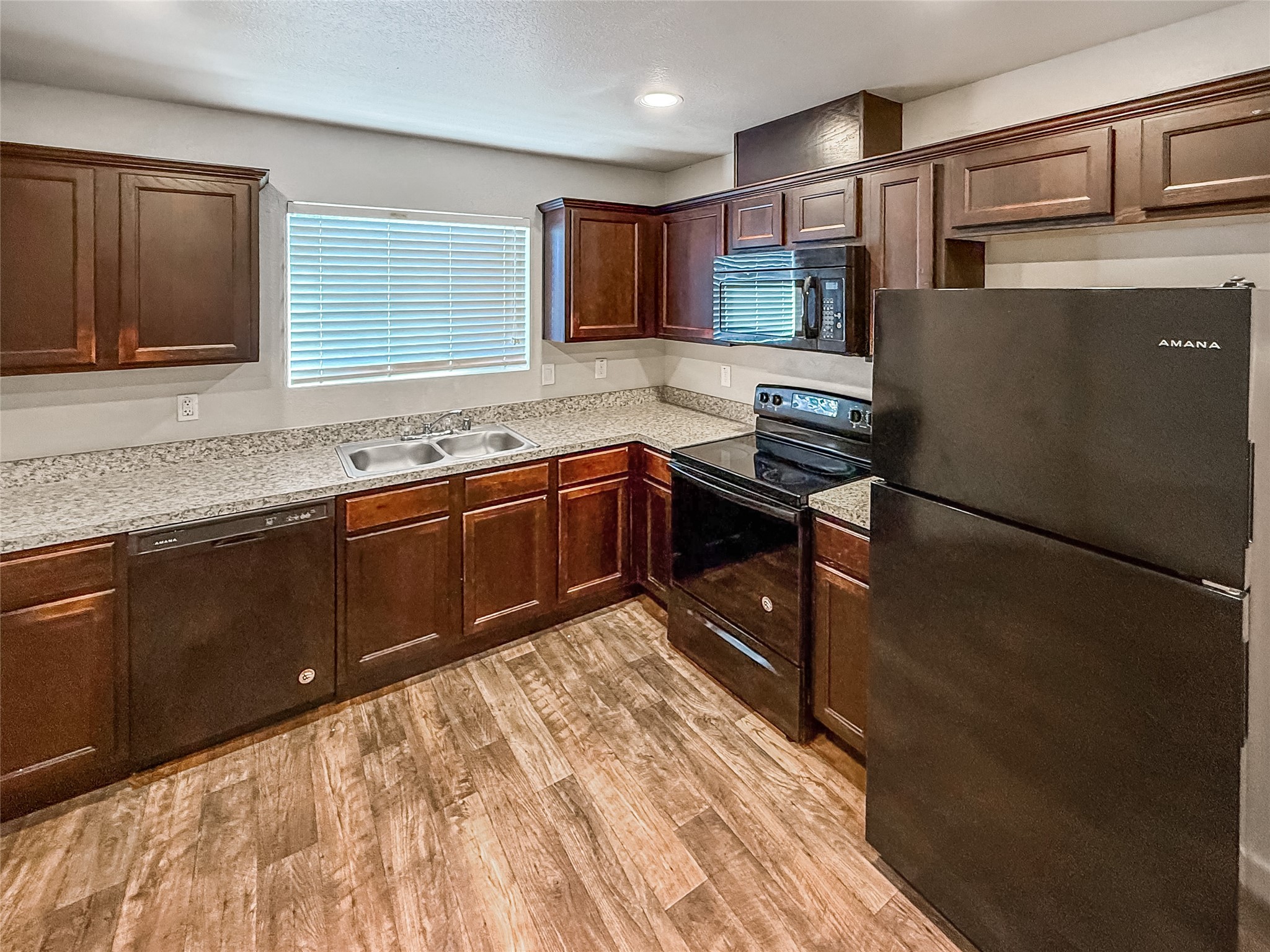 10535 Mills Road, Unit 4B Houston, TX 77070 - Photo 8 of 28 a kitchen with stainless steel appliances granite countertop a sink stove and cabinets