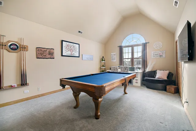 a room with furniture pool table and windows