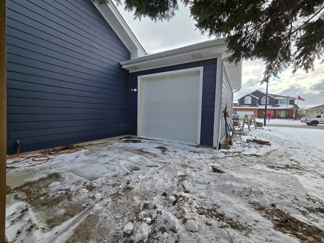 a backyard of a house with table and chairs