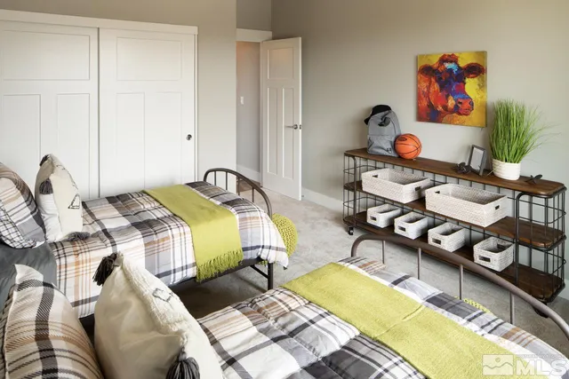 a bedroom with two beds and a window