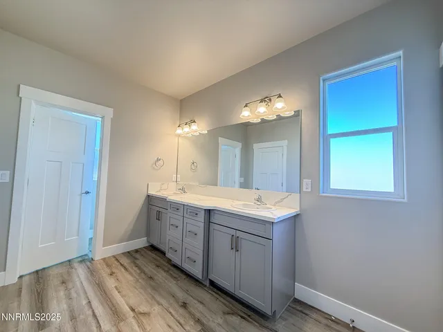 a spacious bathroom with a double vanity sink and a mirror