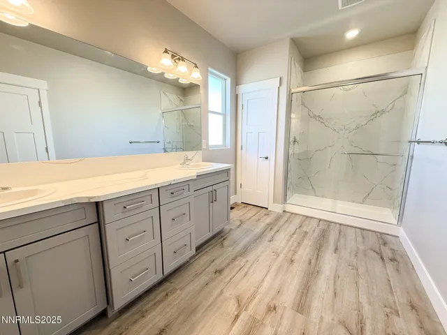 a bathroom with a sink a mirror and shower
