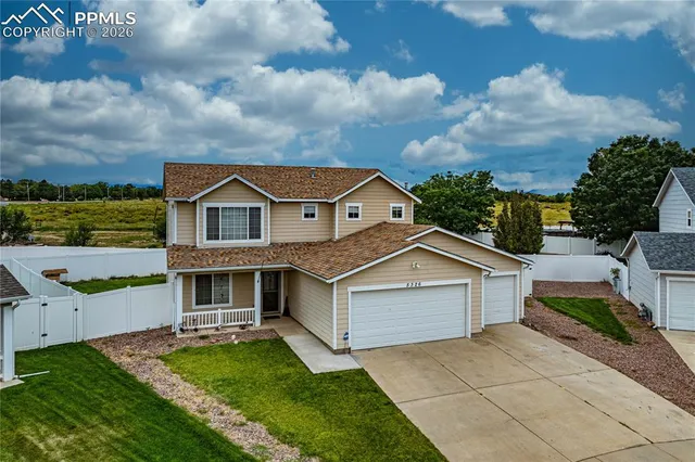 a aerial view of a house with a yard